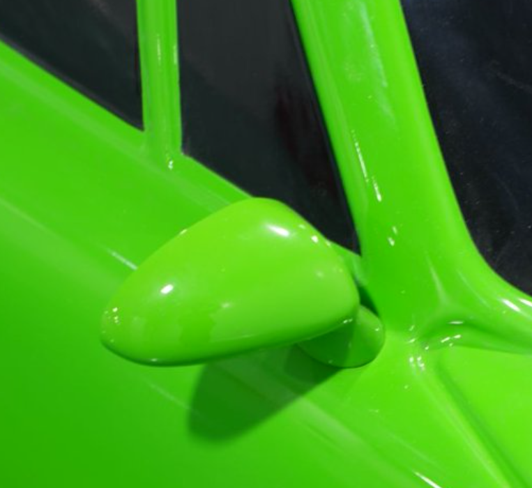 Close-up of side mirror and glossy paint